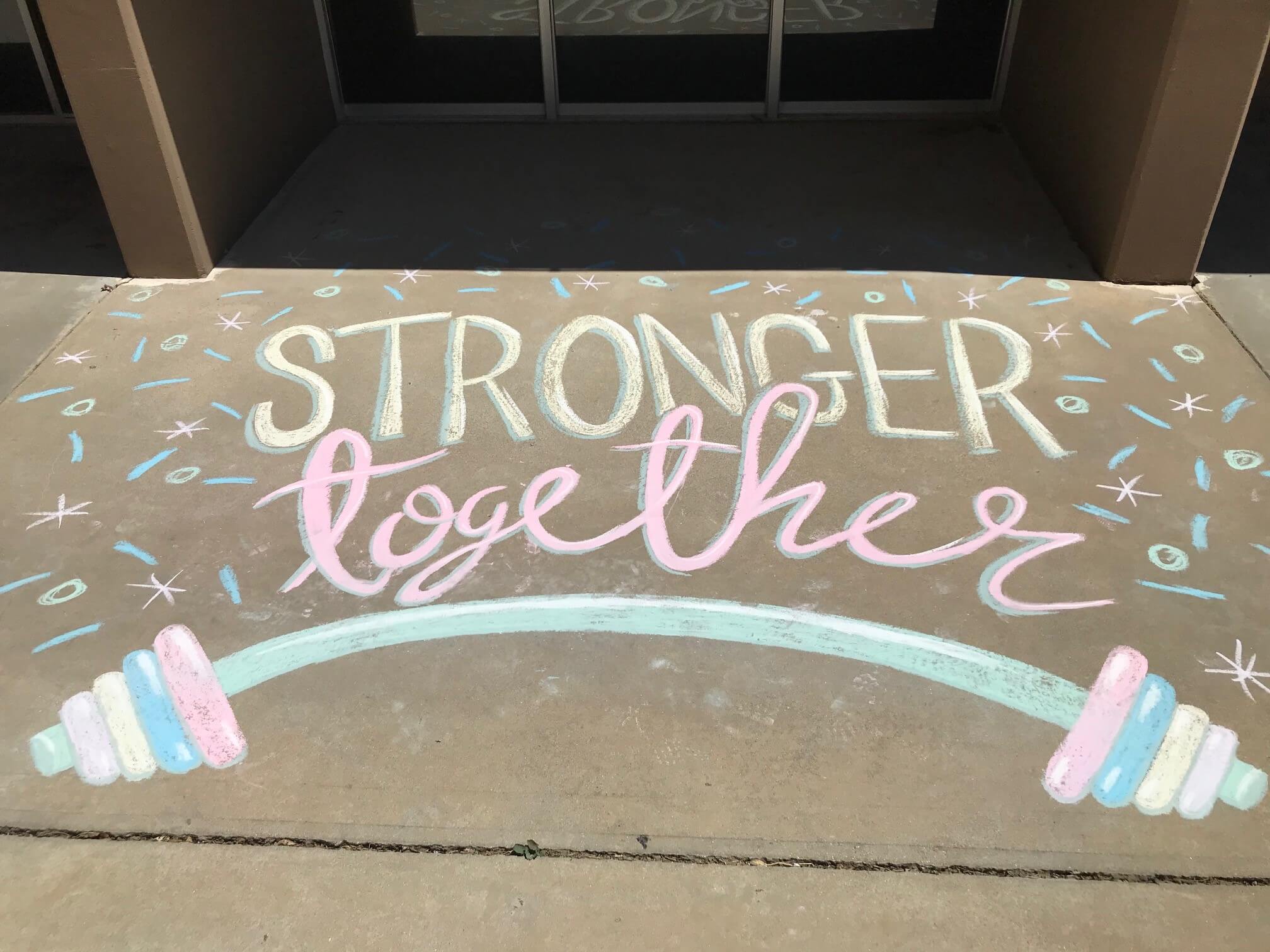 Chalk drawing that says "stronger together"
