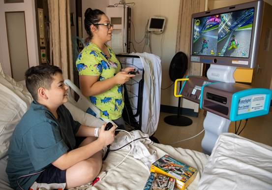 Pediatric patient Roque Larios playing Mario Kart with Maribel